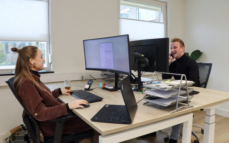 Marjolein en Daniel aan het werk achter hun bureau